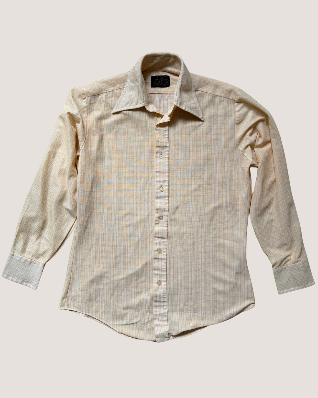 Beige button-up shirt on a light beige background