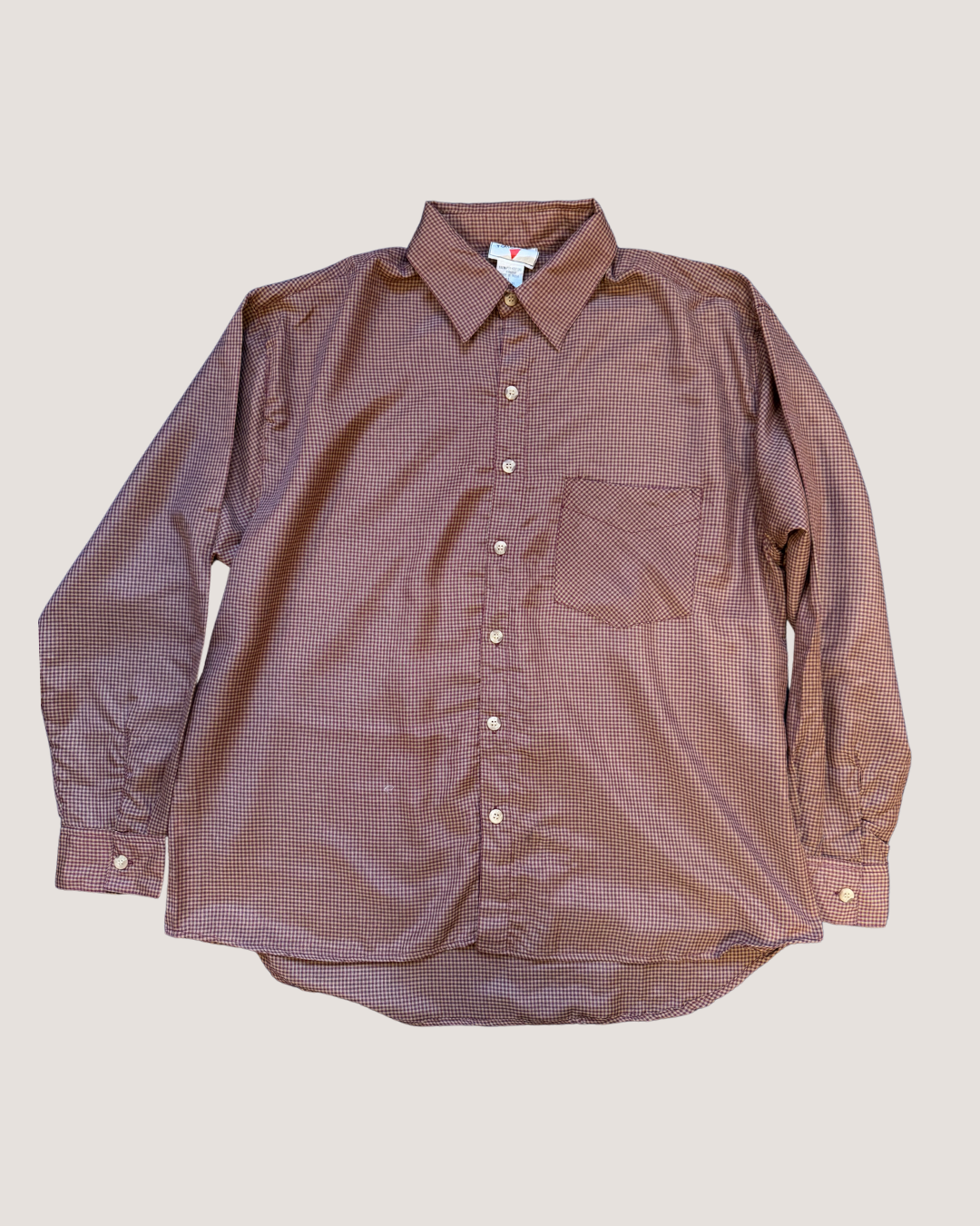 Brown checkered shirt on a beige background