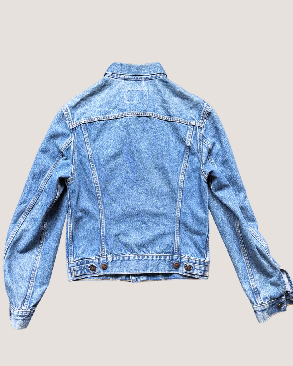 Light blue denim jacket on a light gray background