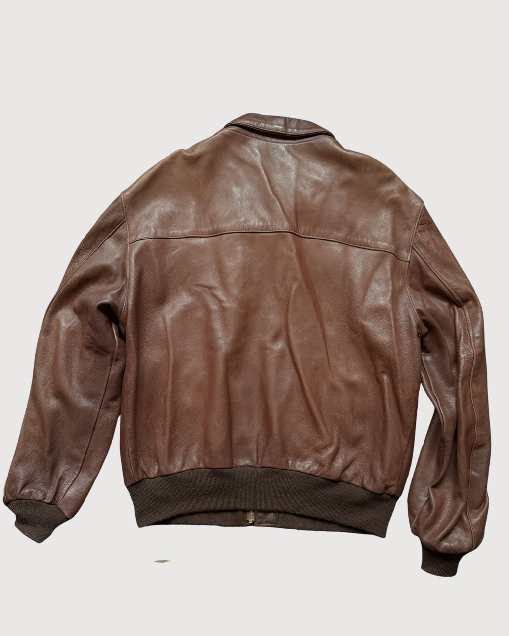 A2 Brown leather jacket on a light gray background