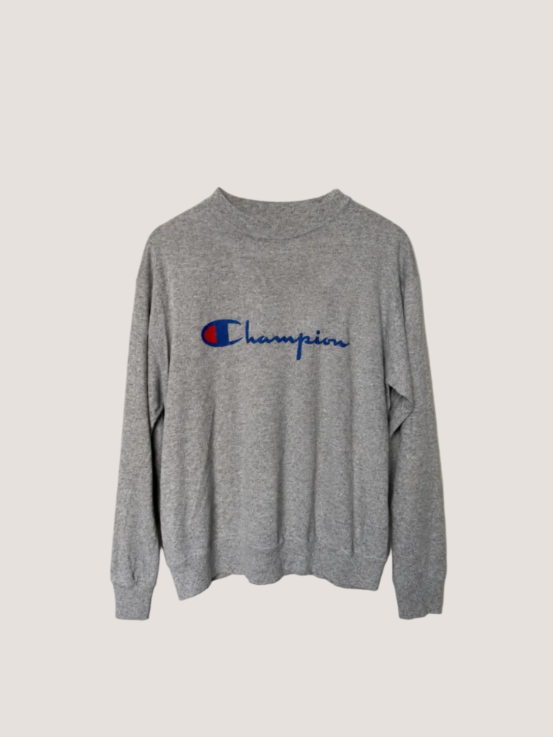 Gray sweatshirt with Champion logo on a light gray background