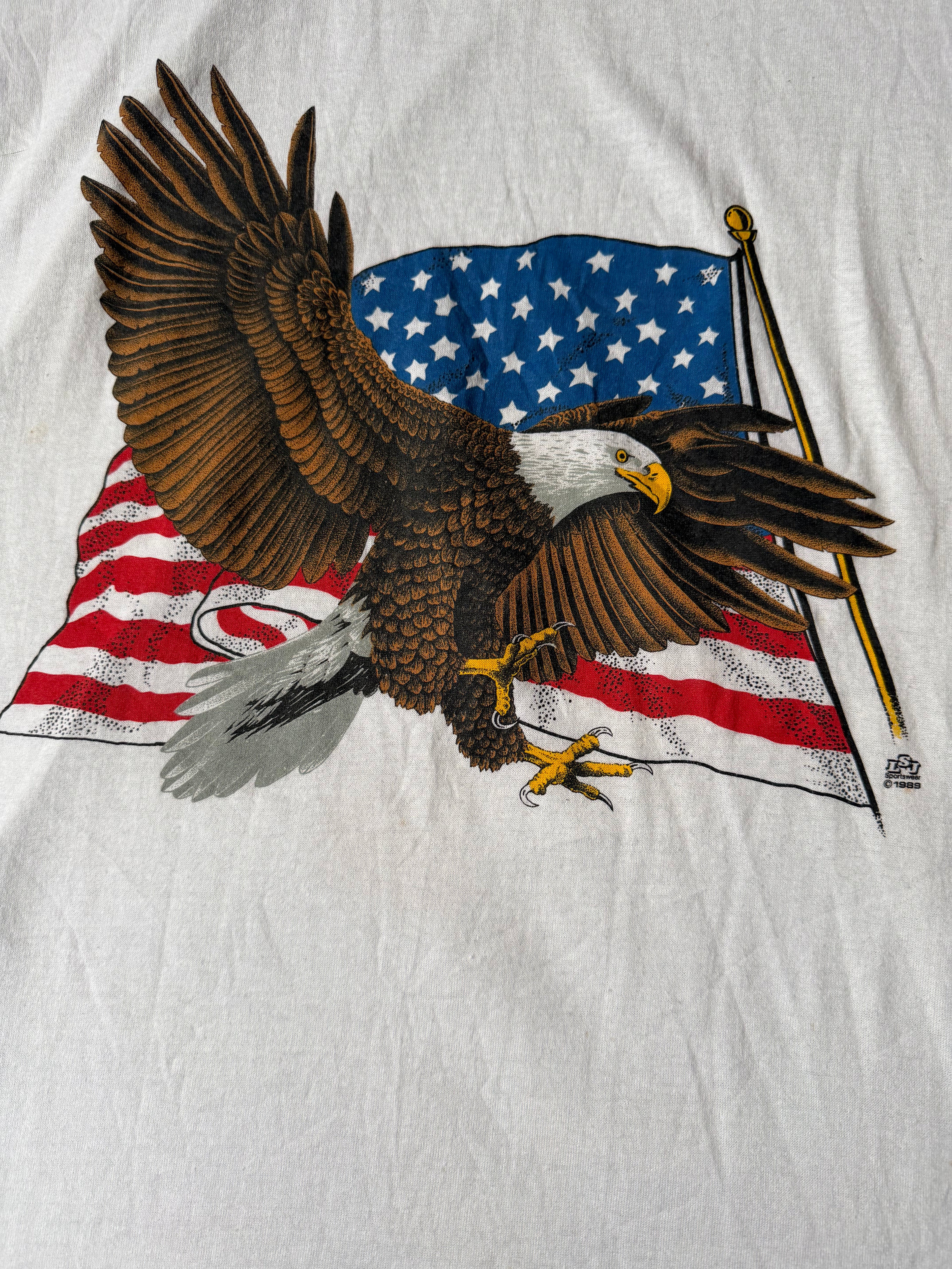 Printed design of an eagle with an American flag on a white fabric background