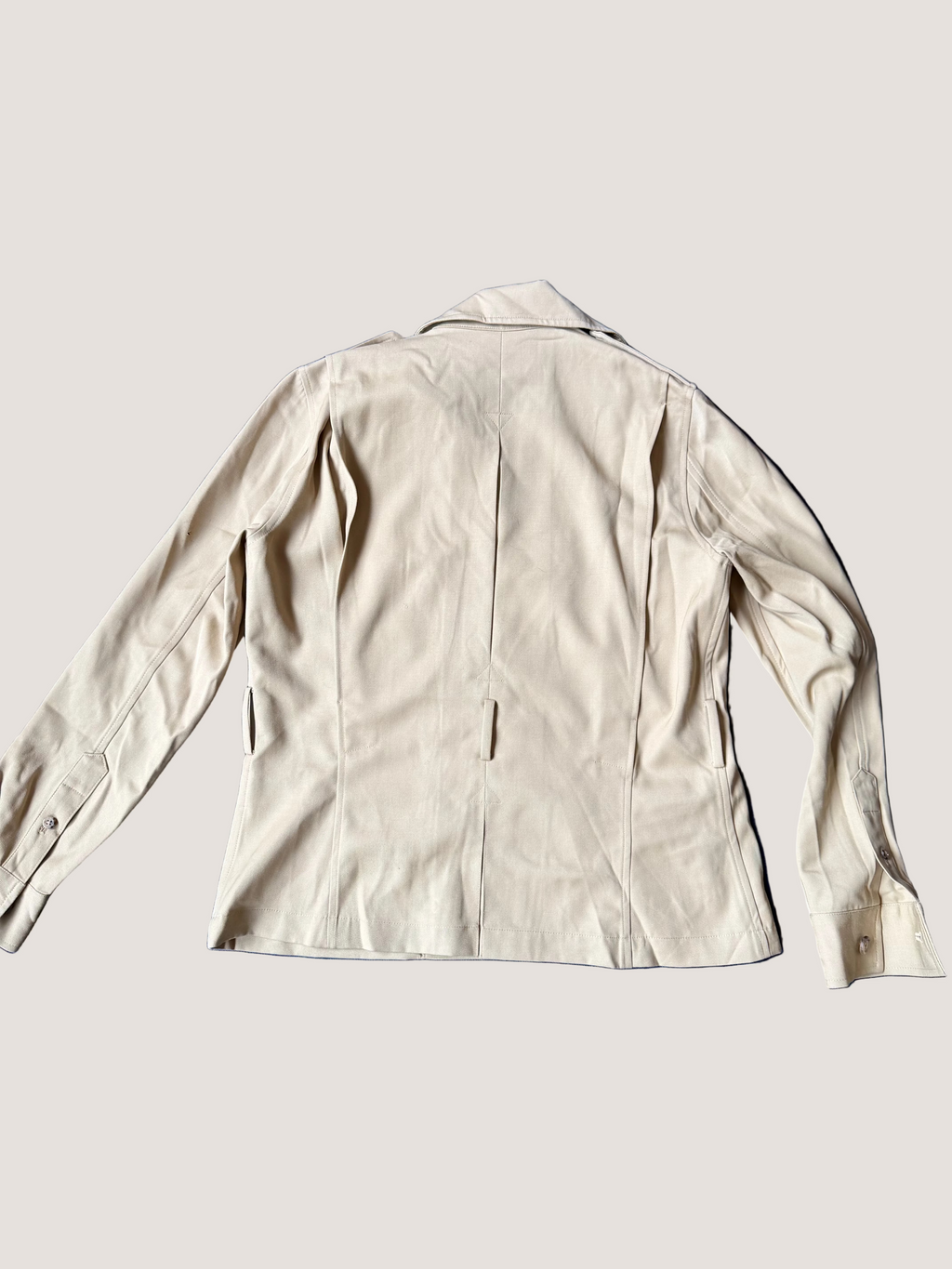 Beige jacket on a blue fabric background