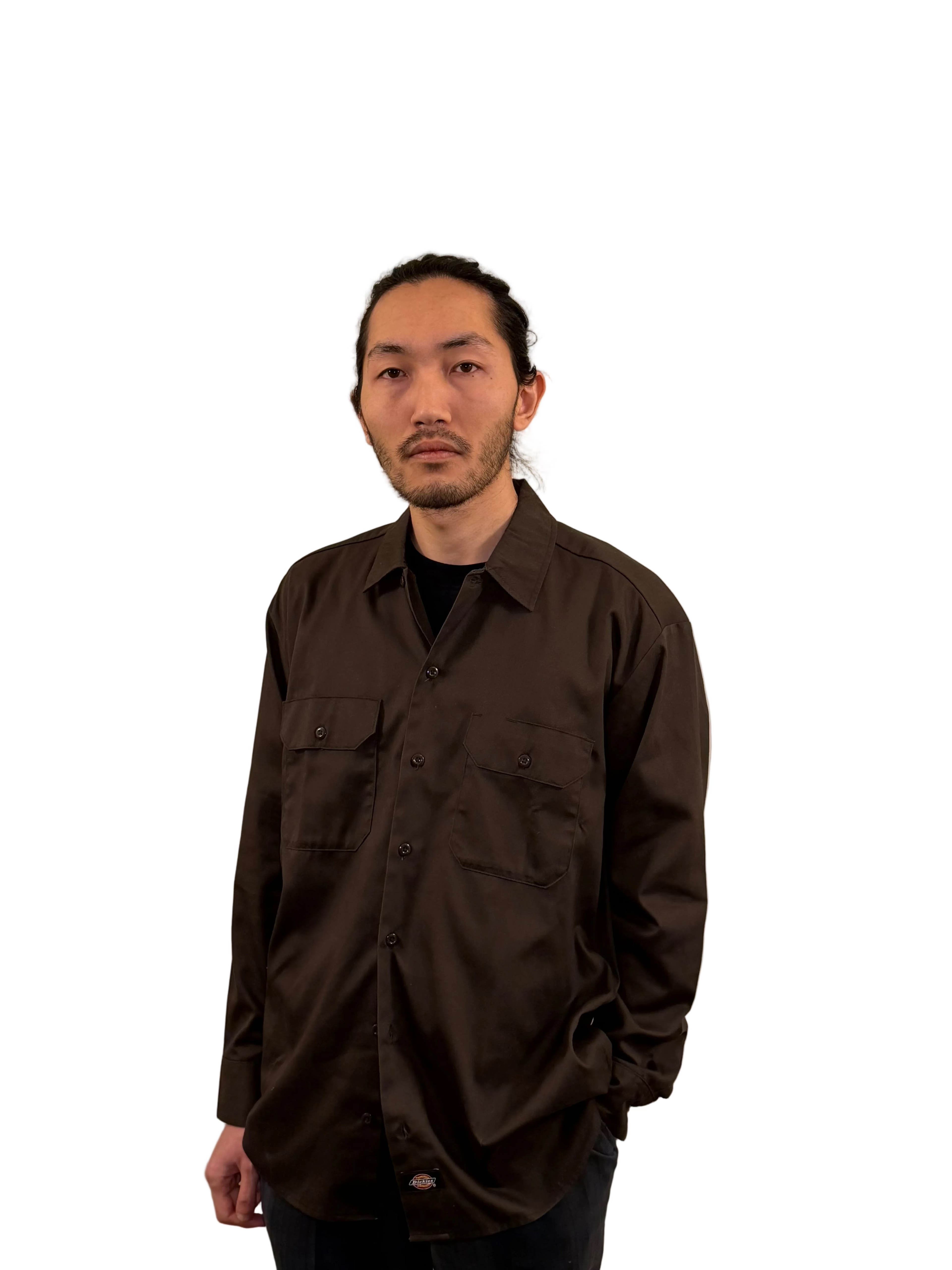 Man wearing a brown shirt against a plain background
