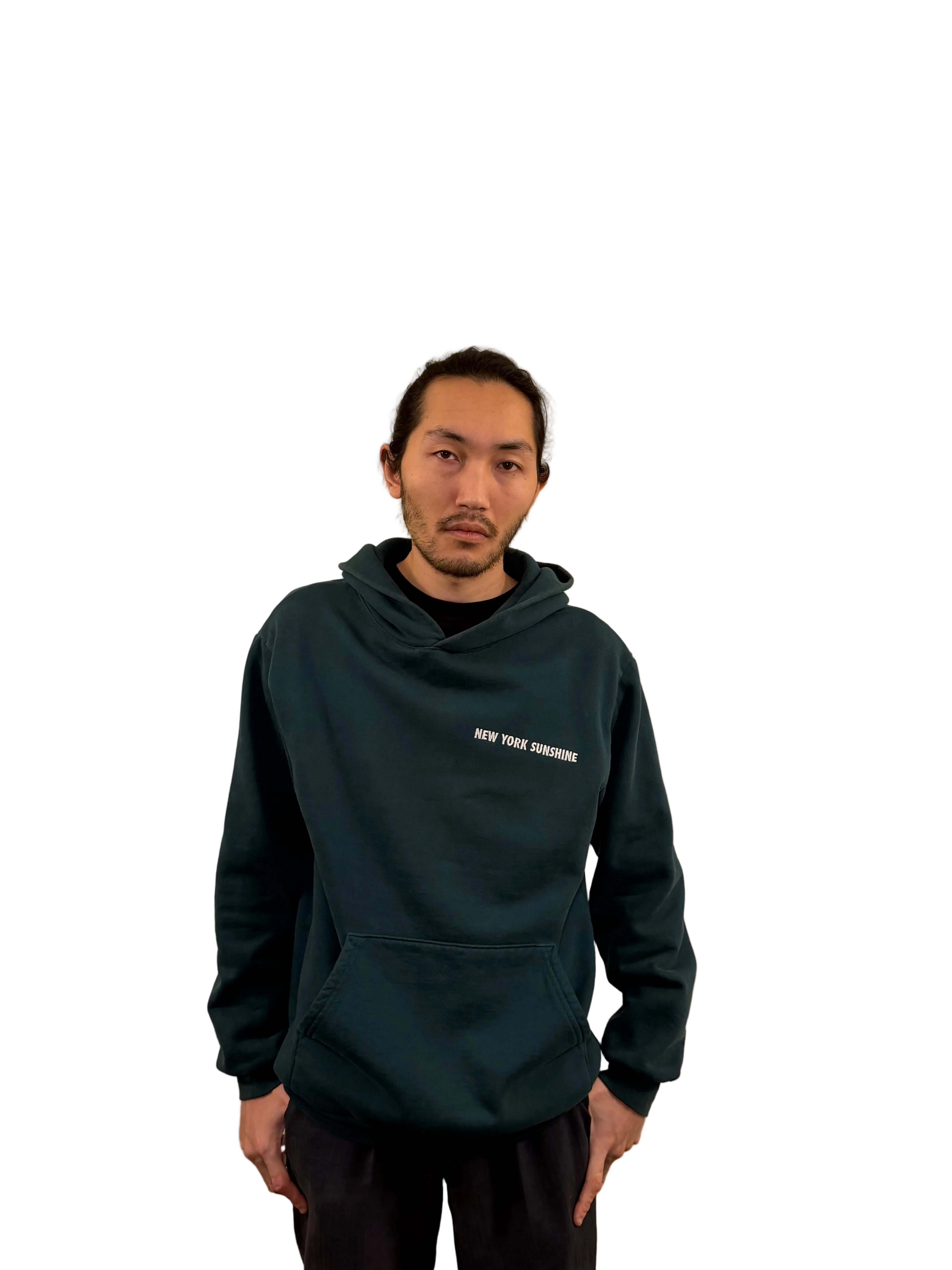 Person wearing a dark green hoodie with text on a beige background