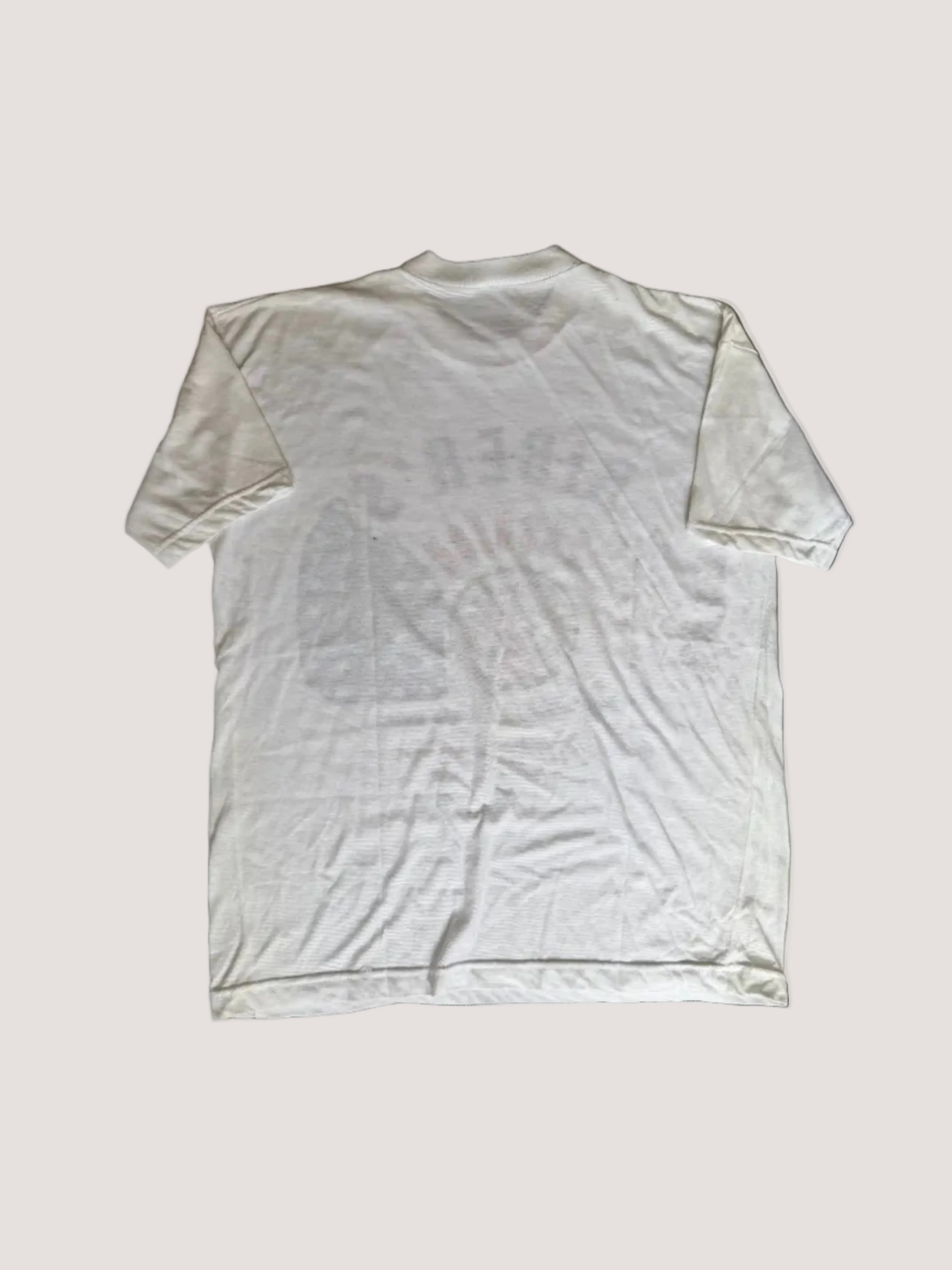 White t-shirt with stains on a brown surface