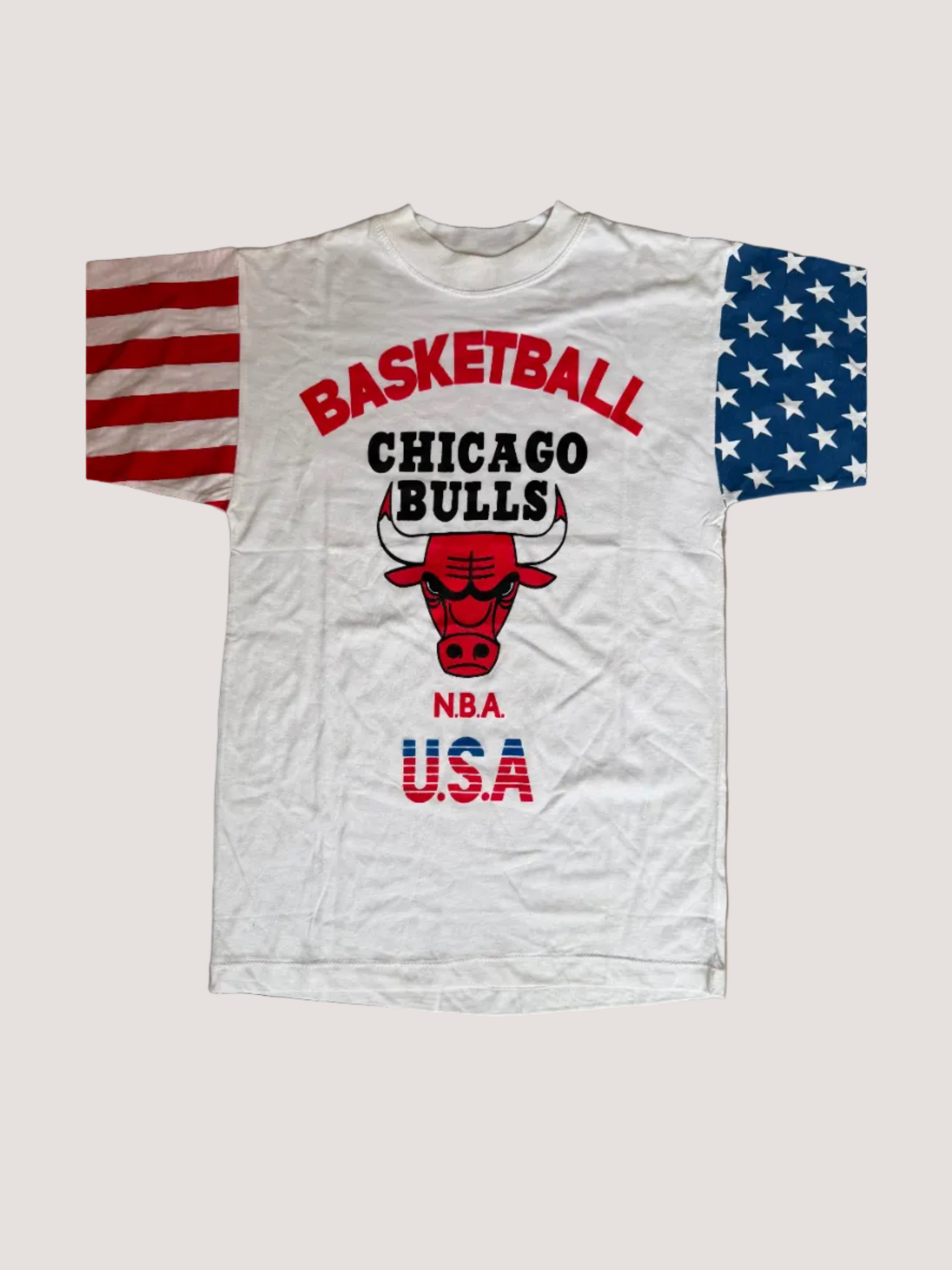 White t-shirt with Chicago Bulls logo and text on a brown surface