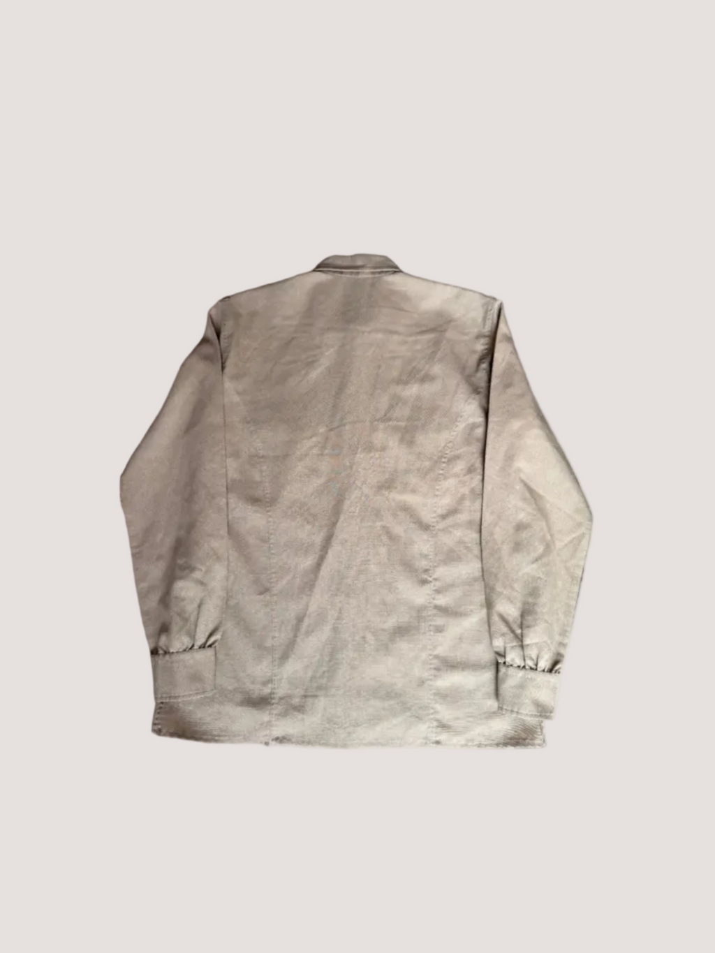 Beige jacket on a textured surface