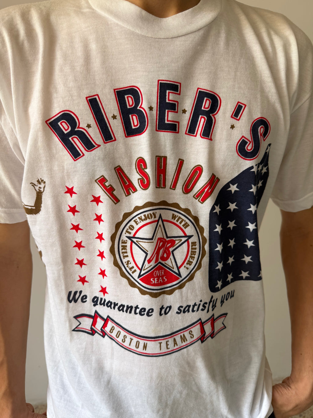 White t-shirt with 'Riber's Fashion' graphic design featuring stars and an American flag.
