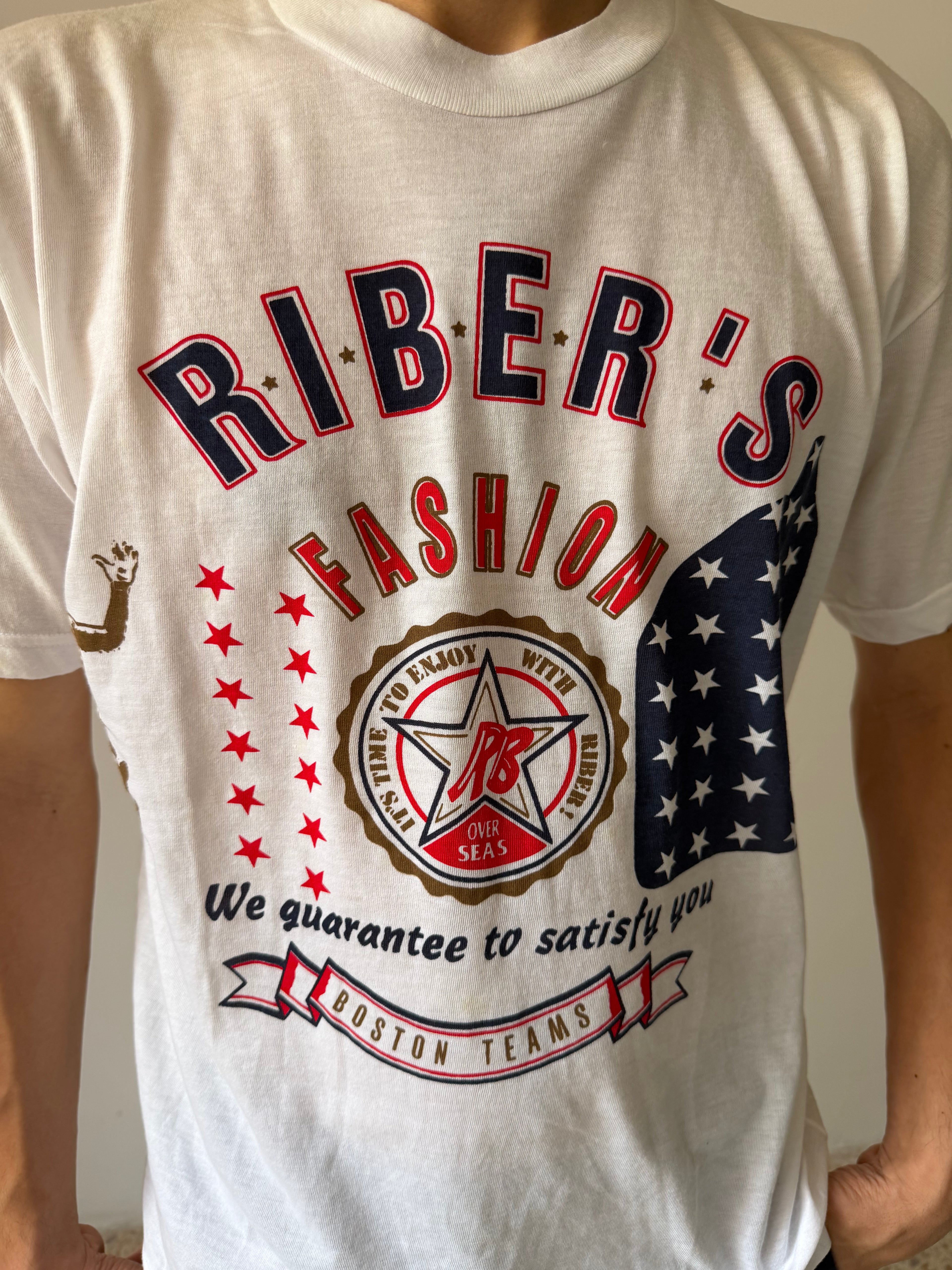 White t-shirt with 'Riber's Fashion' graphic design featuring stars and an American flag.