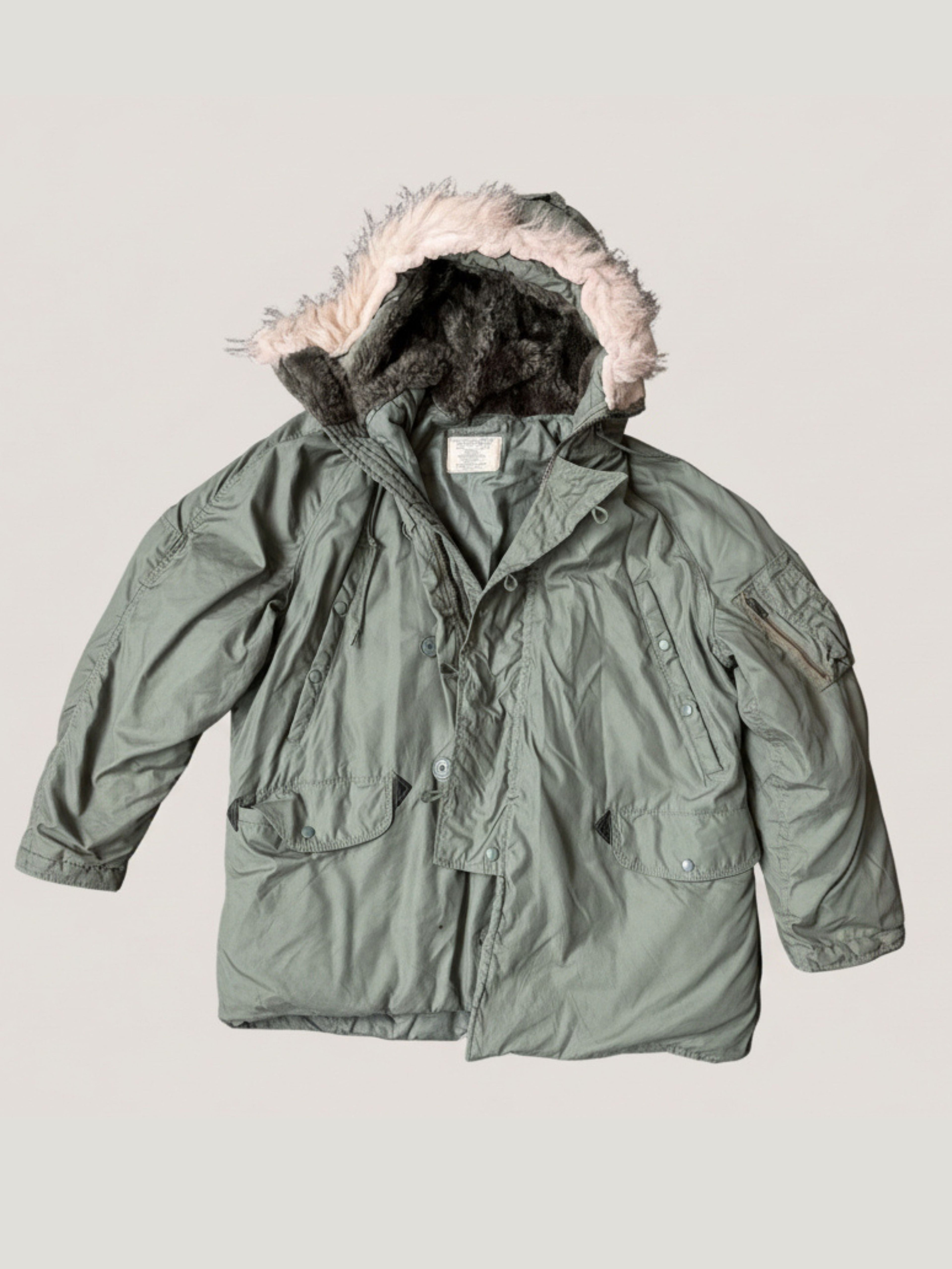 Green Parka N-3B jacket with fur-lined hood on a light gray background