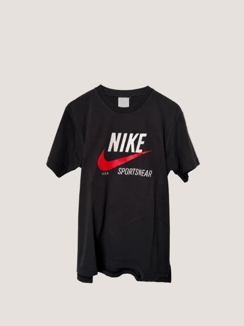 Black Nike Sportswear t-shirt on a light gray background