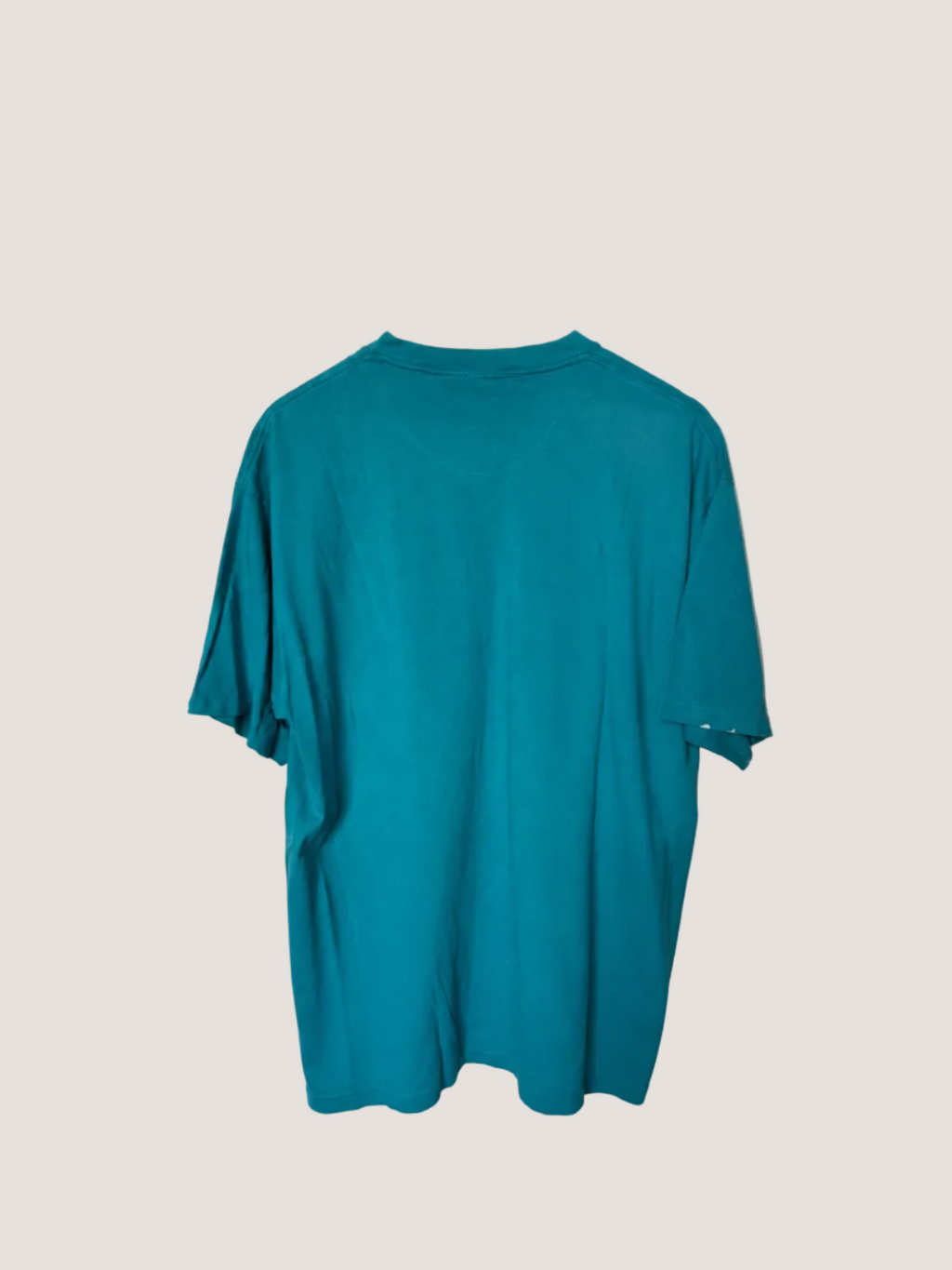 Teal t-shirt on a beige background