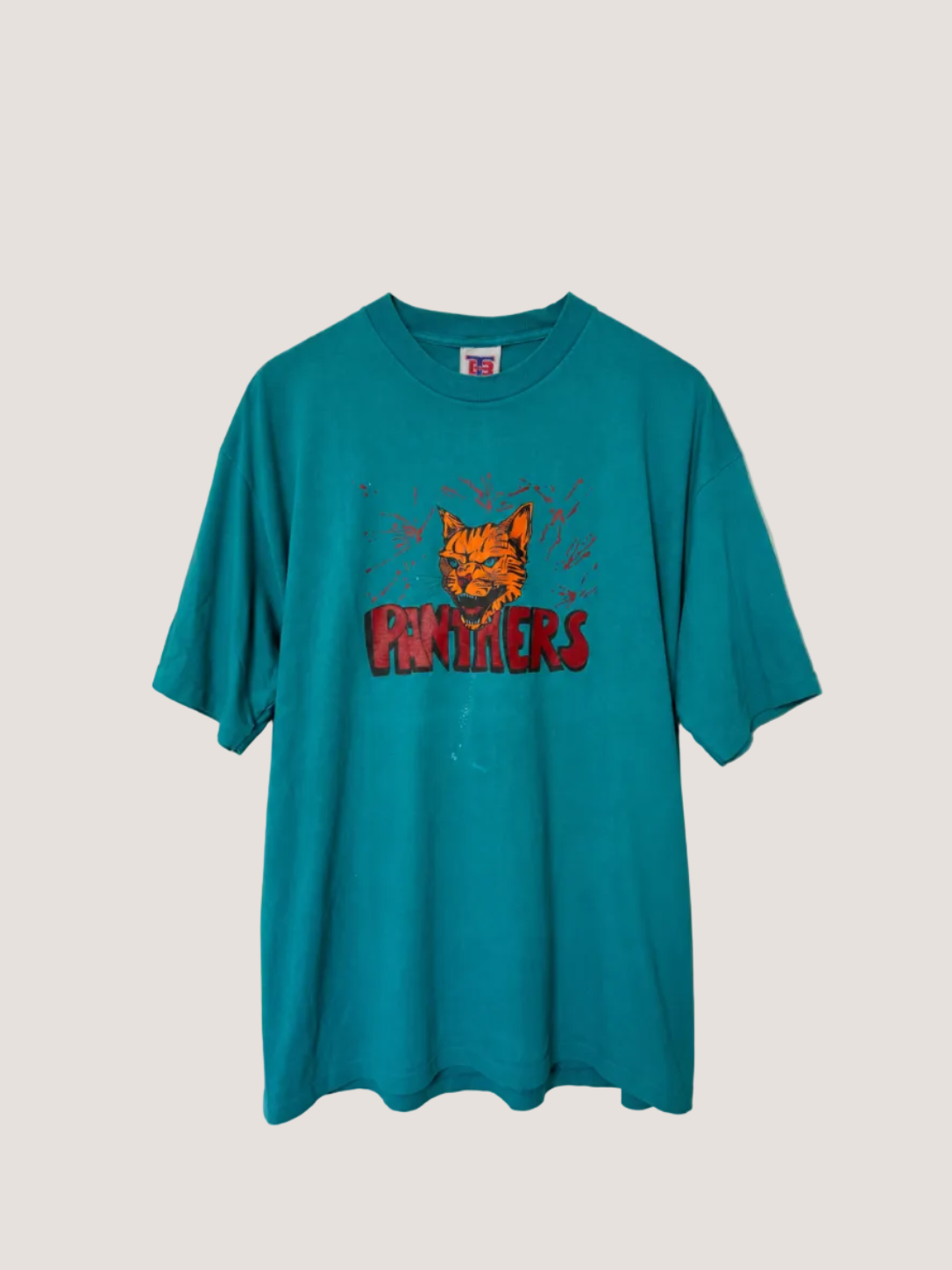 Teal t-shirt with a graphic design on a gray background