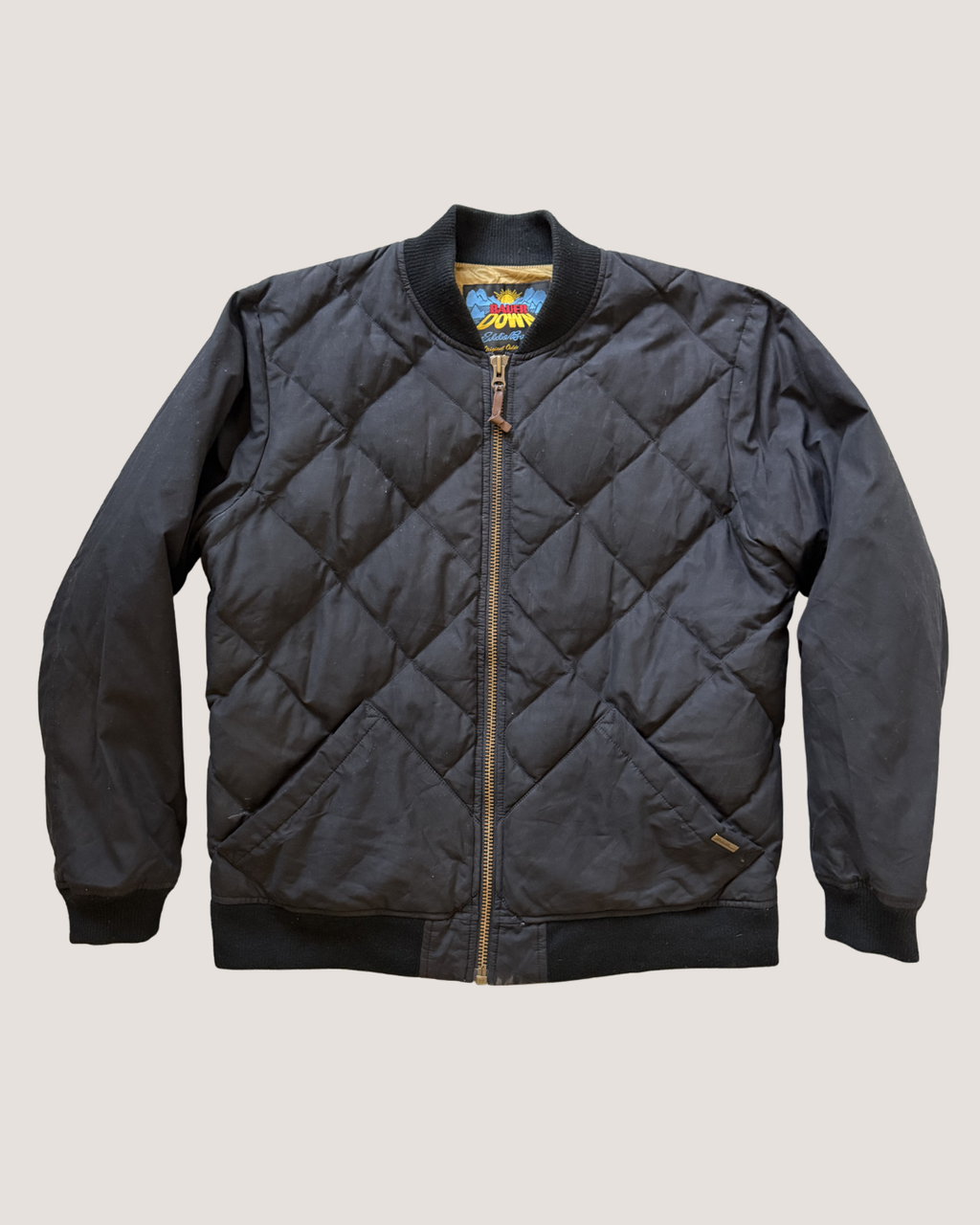 Quilted jacket with brand logo on a light gray background