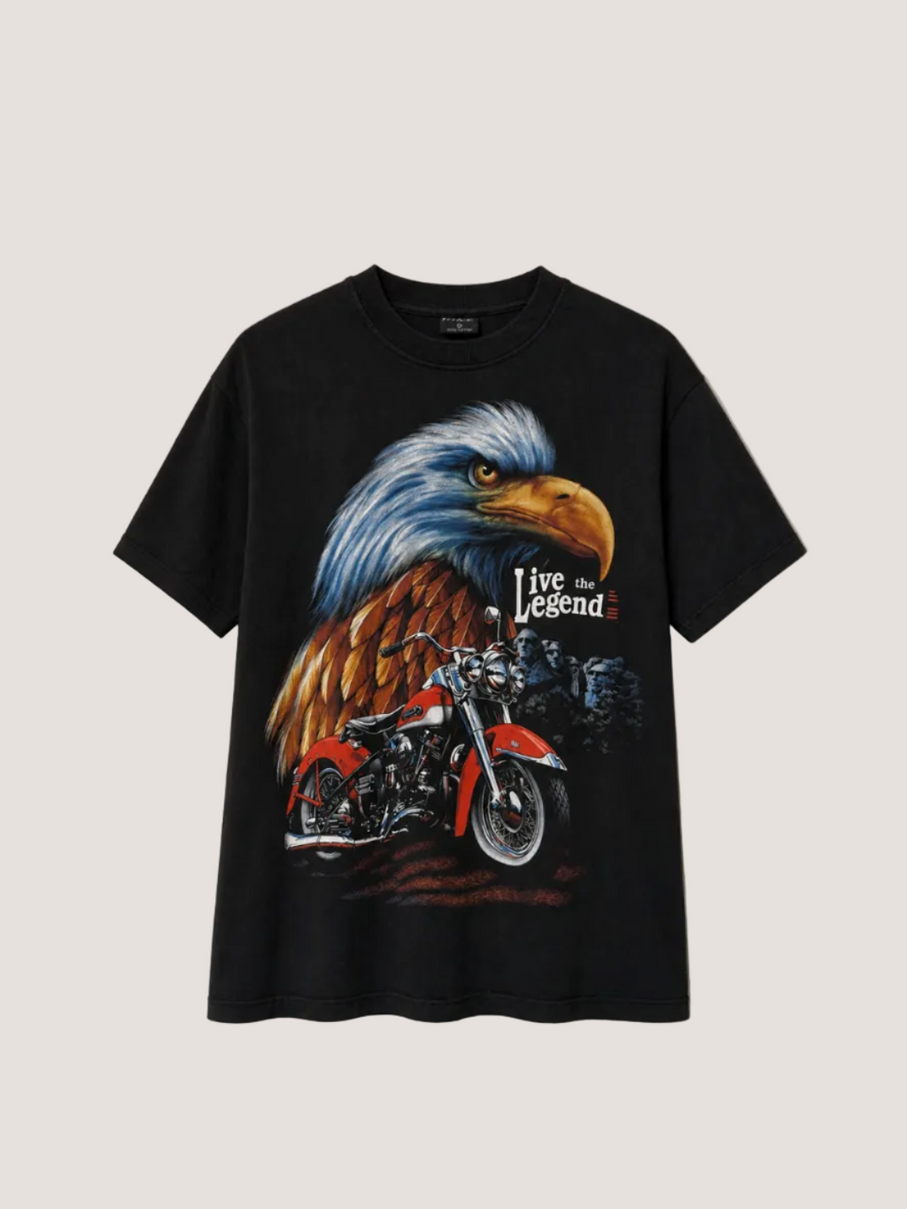 Black t-shirt with an eagle and motorcycle graphic on a beige background